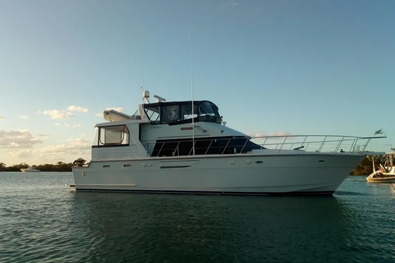 Traveller Yacht Photos Pics 1996 Jefferson 52 Rivanna Cockpit MY yacht on calm water at sunset.