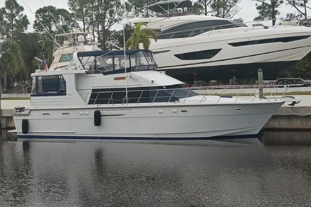 Traveller Yacht Photos Pics 1996 Jefferson 52 Rivanna Cockpit MY yacht docked in a marina, side view.