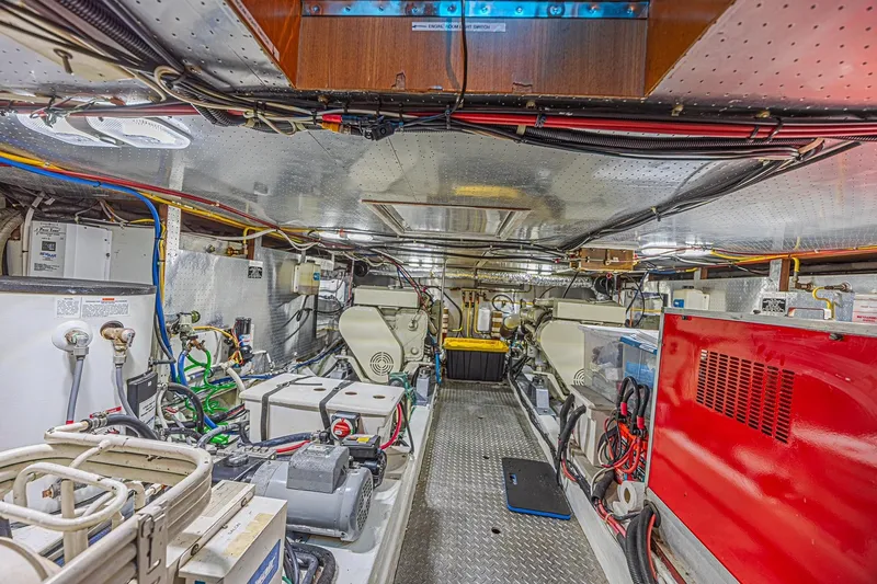 Traveller Yacht Photos Pics Engine room of a 1996 Jefferson 52 Rivanna Cockpit MY yacht, showcasing machinery and wiring.