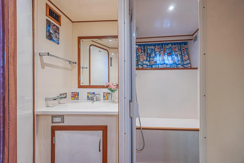 Traveller Yacht Photos Pics Bathroom interior of 1996 Jefferson 52 Rivanna Cockpit MY yacht, featuring nautical-themed decor.