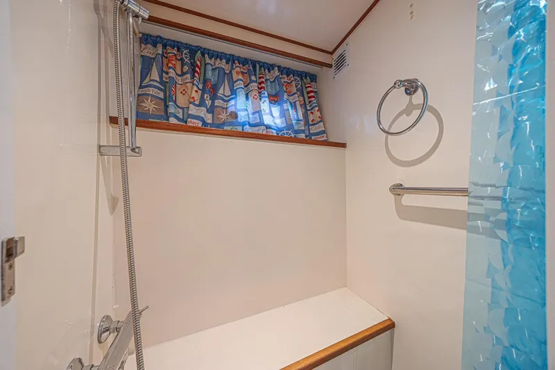 Traveller Yacht Photos Pics Bathroom interior of 1996 Jefferson 52 Rivanna Cockpit MY with nautical-themed curtains.