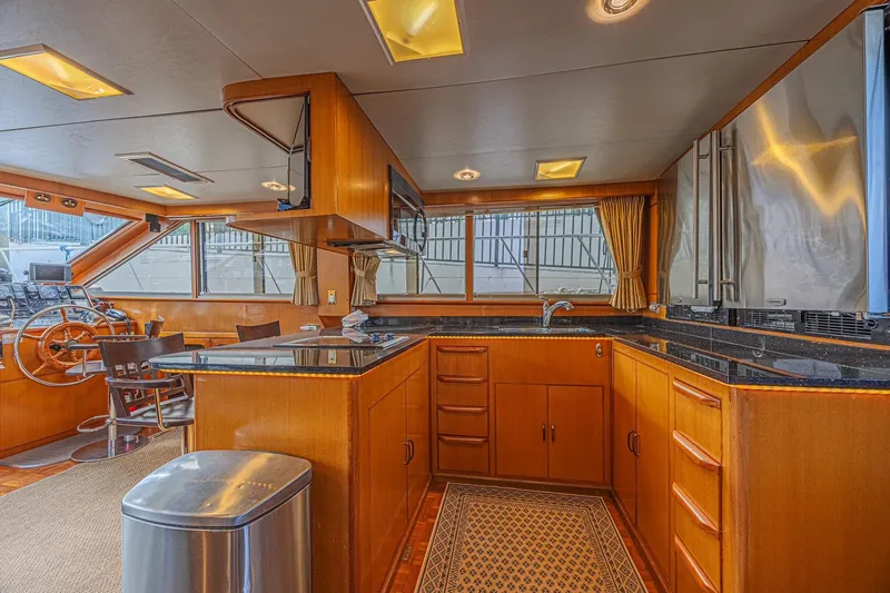 Traveller Yacht Photos Pics Luxurious interior of 1996 Jefferson 52 Rivanna Cockpit MY yacht with modern kitchen and helm.