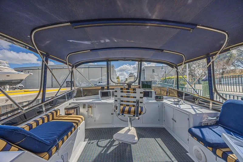 Traveller Yacht Photos Pics 1996 Jefferson 52 Rivanna Cockpit MY interior with striped seating and navigation equipment.