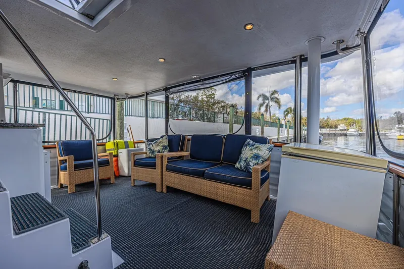 Traveller Yacht Photos Pics Spacious cockpit of 1996 Jefferson 52 Rivanna yacht with wicker seating and marina view.