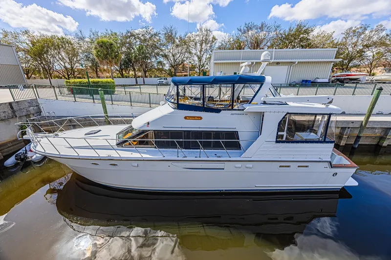 Traveller Yacht Photos Pics 1996 Jefferson 52 Rivanna Cockpit MY yacht docked, featuring sleek design and spacious deck.