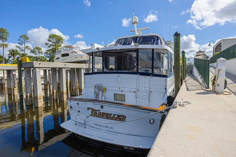 Traveller Yacht Photos Pics 1996 Jefferson 52 Rivanna Cockpit MY docked at marina under blue sky.