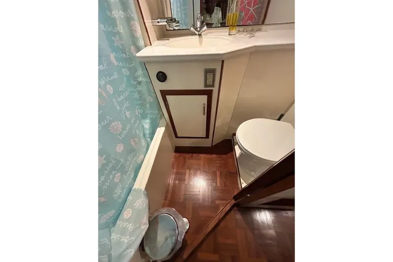 Traveller Yacht Photos Pics Bathroom interior of 1996 Jefferson 52 Rivanna Cockpit MY yacht, featuring sink and toilet.