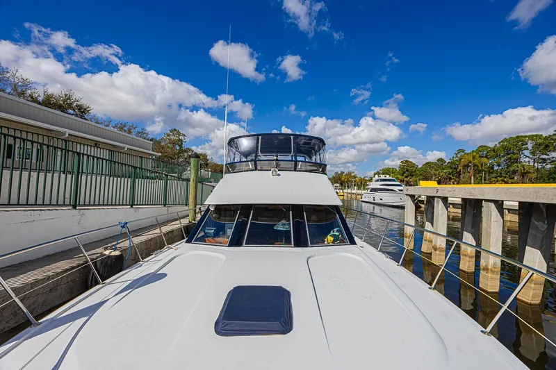Traveller Yacht Photos Pics 1996 Jefferson 52 Rivanna Cockpit MY yacht docked under a vibrant blue sky.