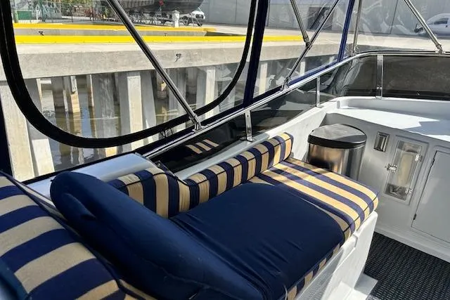 Traveller Yacht Photos Pics 1996 Jefferson 52 Rivanna Cockpit MY with striped seating and enclosed cockpit view.