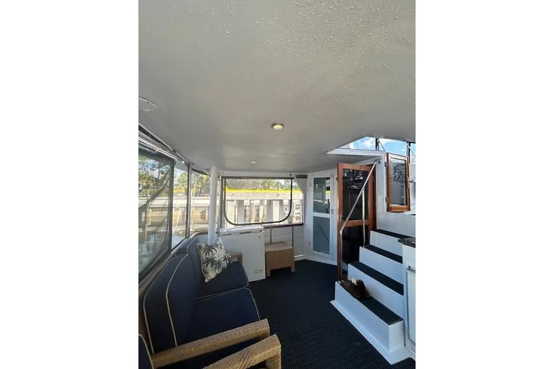 Traveller Yacht Photos Pics Interior of 1996 Jefferson 52 Rivanna Cockpit MY yacht, featuring seating and stairs.