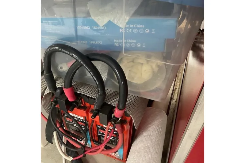 Traveller Yacht Photos Pics Battery charger with cables in a storage area on a 1996 Jefferson 52 Rivanna Cockpit MY.