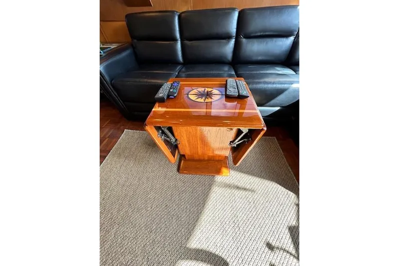 Traveller Yacht Photos Pics Luxurious Jefferson 52 Rivanna Cockpit MY interior with elegant wooden table and leather seating.