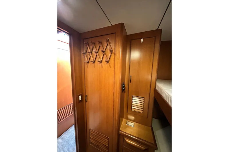 Traveller Yacht Photos Pics Interior of 1996 Jefferson 52 Rivanna Cockpit MY with wooden cabinetry and bunk bed.