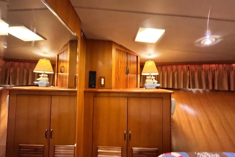 Traveller Yacht Photos Pics Interior of 1996 Jefferson 52 Rivanna Cockpit MY with wooden cabinets and lamps.