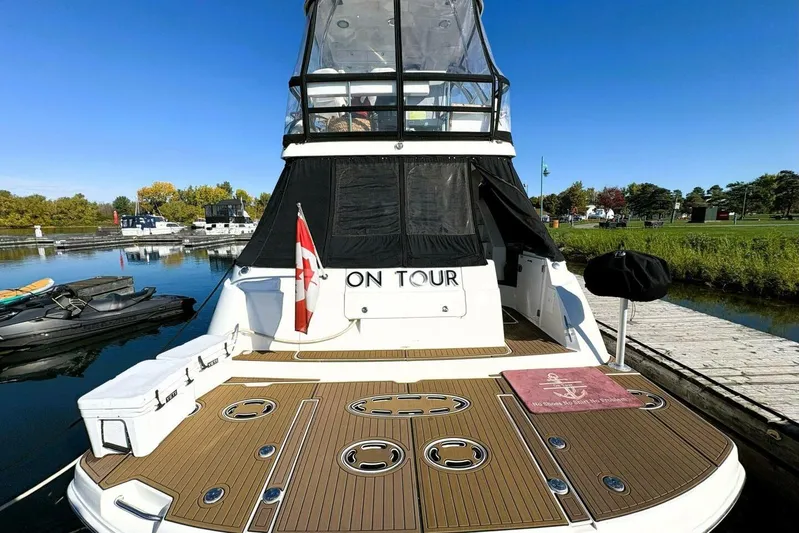  Yacht Photos Pics 2008 Sea Ray 47 Sedan Bridge yacht docked, featuring spacious deck and Canadian flag.