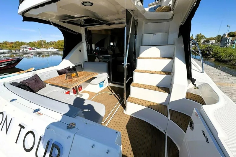  Yacht Photos Pics 2008 Sea Ray 47 Sedan Bridge yacht with outdoor seating and staircase, docked by the water.
