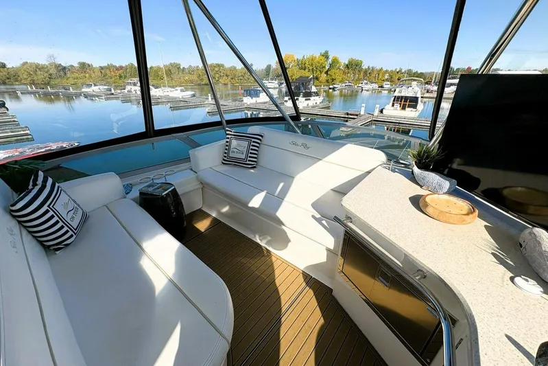 Yacht Photos Pics Luxurious 2008 Sea Ray 47 Sedan Bridge interior with marina view, featuring elegant seating and decor.