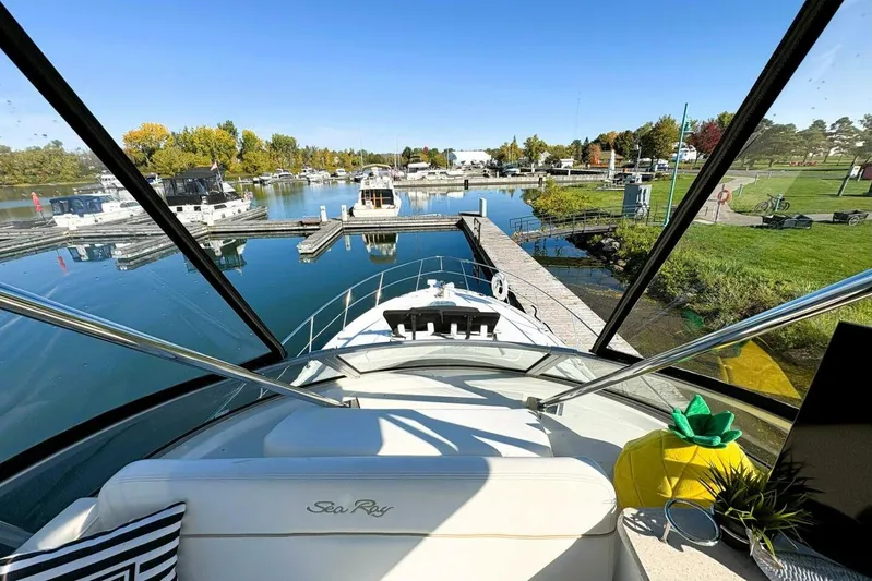  Yacht Photos Pics 2008 Sea Ray 47 Sedan Bridge yacht docked at a scenic marina with clear skies.