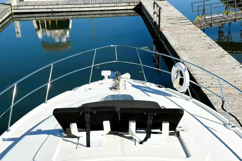  Yacht Photos Pics 2008 Sea Ray 47 Sedan Bridge yacht docked at a marina, calm water reflection.