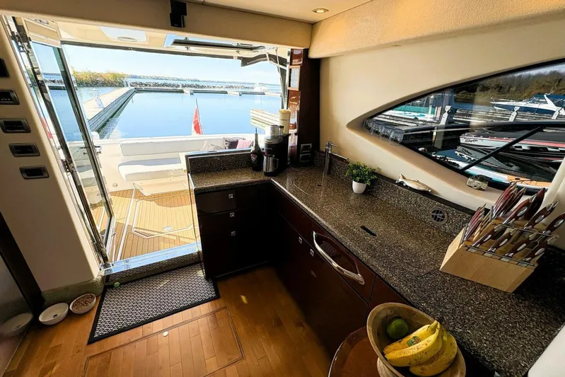  Yacht Photos Pics Luxurious 2008 Sea Ray 47 Sedan Bridge yacht interior with modern kitchen and marina view.