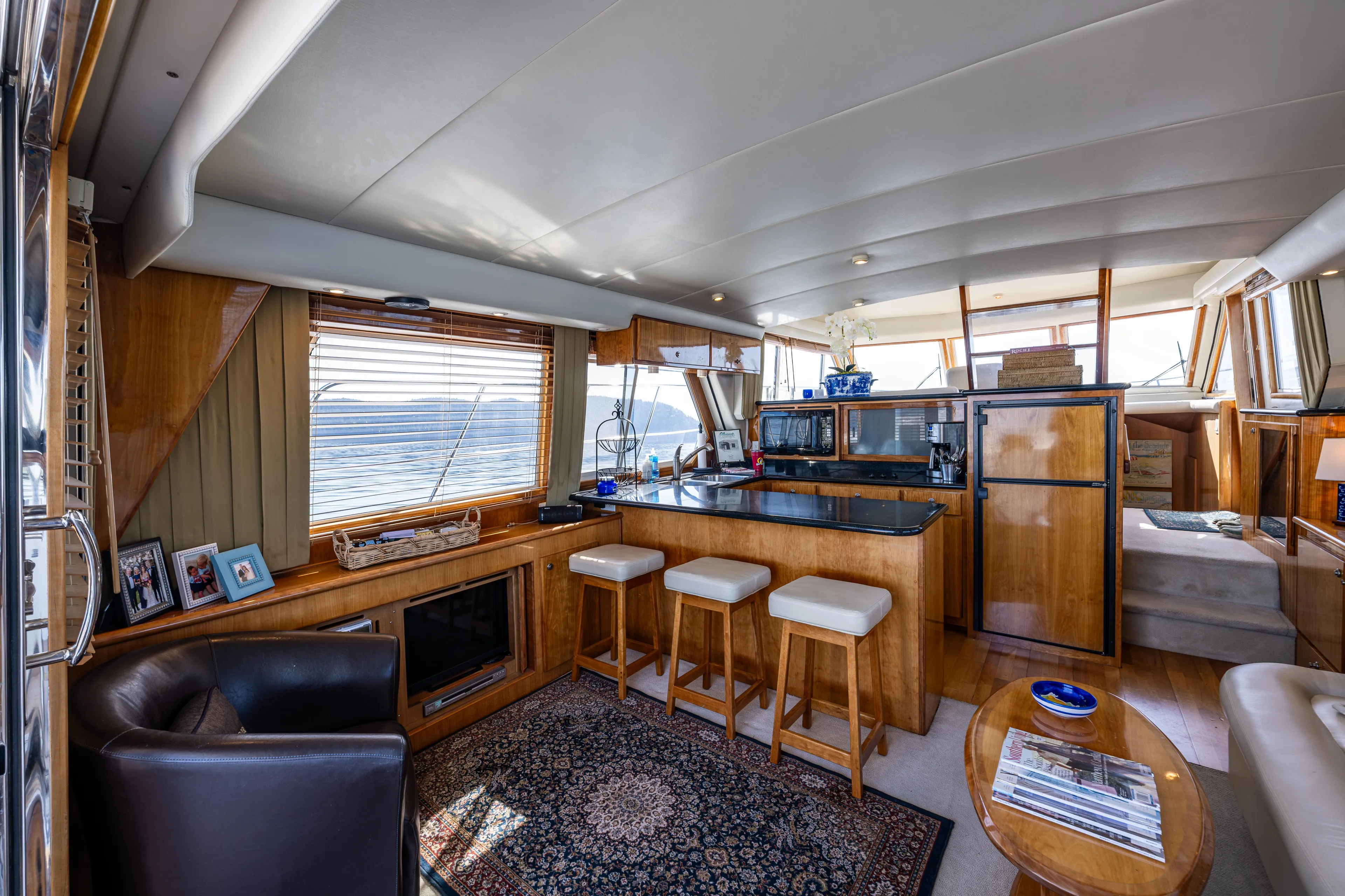 Clancy's Yacht Photos Pics Luxurious interior of 2004 Navigator Classic 5300 yacht with modern kitchen and seating area.