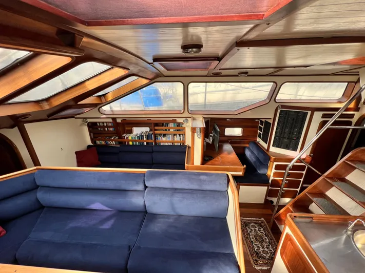 Malabar Yacht Photos Pics Interior of 2014 Custom 53' Expedition Voyaging Lifting Keeler with blue seating and wooden accents.