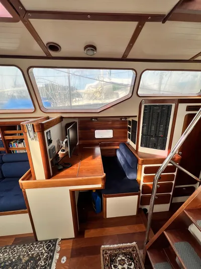 Malabar Yacht Photos Pics Interior of 2014 Custom 53' Expedition Voyaging Lifting Keeler with wood finish and seating area.