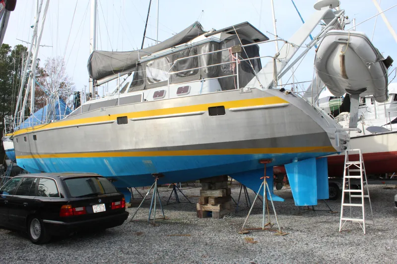Malabar Yacht Photos Pics Custom 53' Expedition Voyaging Lifting Keeler, 2014, on dry dock with blue and yellow accents.
