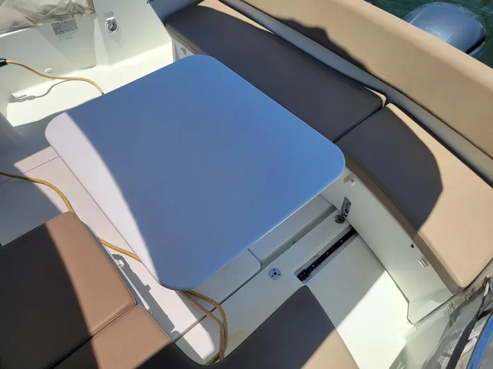 Supervielle Yacht Photos Pics 2016 Jeanneau Merry Fisher 855 boat interior with cushioned seating and table.