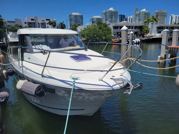 Supervielle Yacht Photos Pics 2016 Jeanneau Merry Fisher 855 docked in a marina with city skyline.