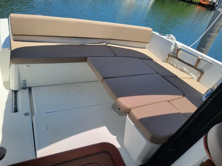 Supervielle Yacht Photos Pics Jeanneau Merry Fisher 855, 2016 model, featuring spacious outdoor seating by the water.