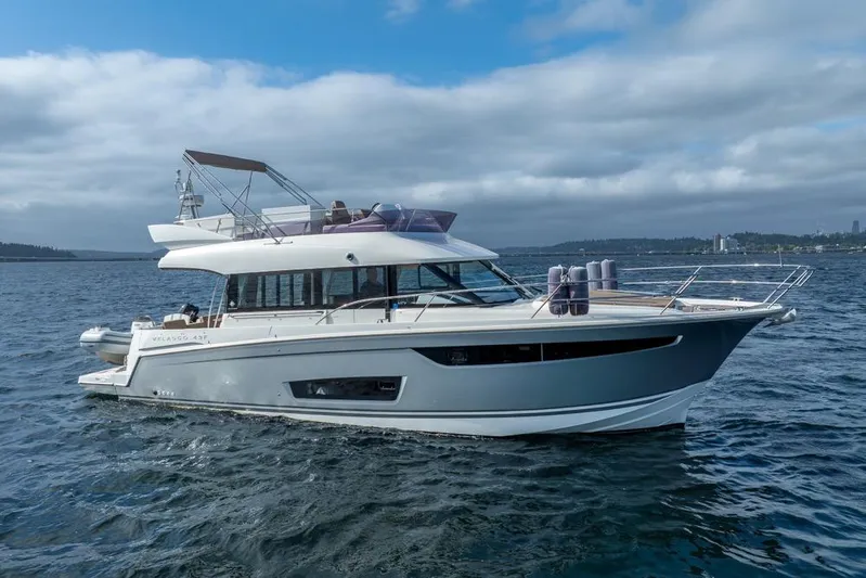  Yacht Photos Pics 2016 Jeanneau Velasco 43F yacht cruising on open water under cloudy skies.