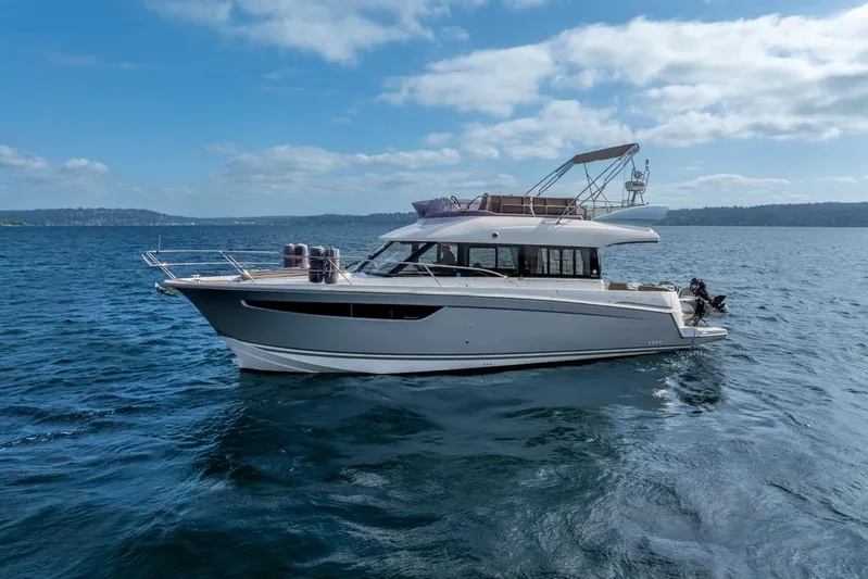  Yacht Photos Pics 2016 Jeanneau Velasco 43F yacht cruising on open water under a clear blue sky.