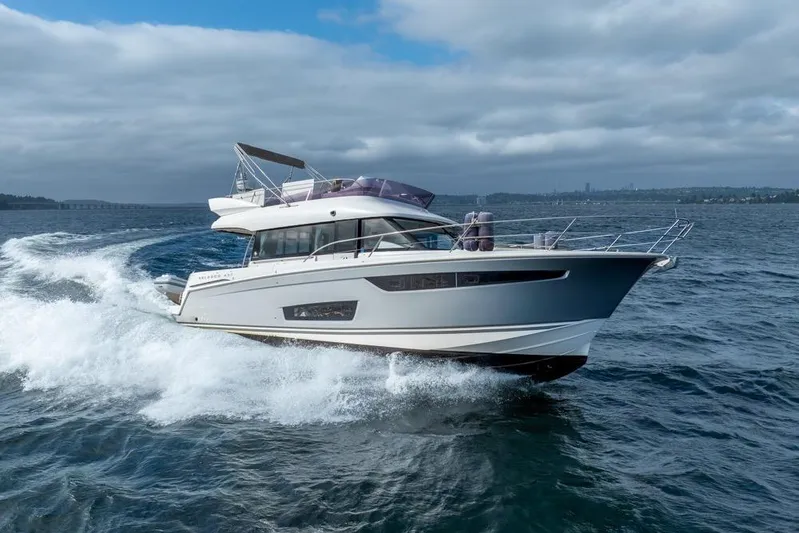  Yacht Photos Pics 2016 Jeanneau Velasco 43F yacht cruising on open water under cloudy skies.