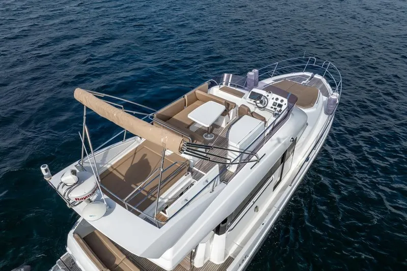  Yacht Photos Pics 2016 Jeanneau Velasco 43F yacht on open water, featuring spacious deck and seating area.