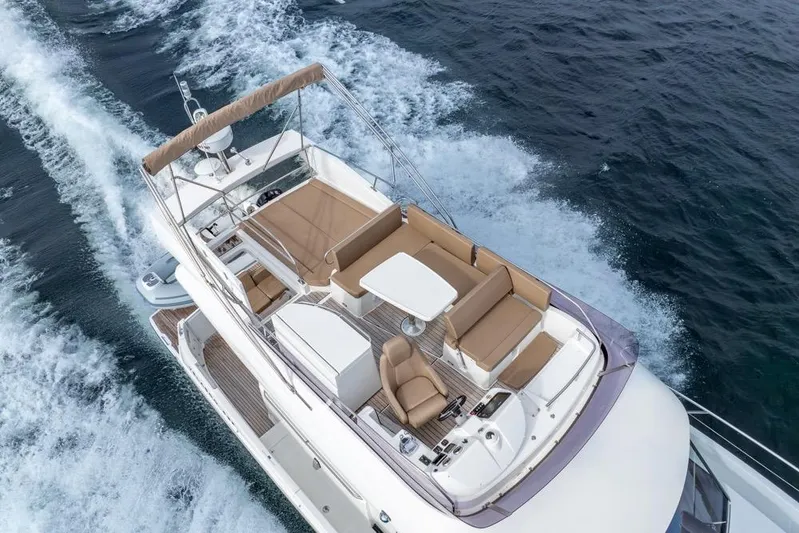  Yacht Photos Pics 2016 Jeanneau Velasco 43F yacht cruising on open water, aerial view.