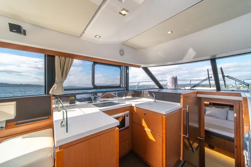  Yacht Photos Pics Interior of 2016 Jeanneau Velasco 43F yacht with modern kitchen and scenic ocean view.