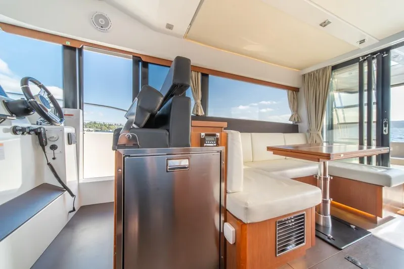  Yacht Photos Pics Interior of 2016 Jeanneau Velasco 43F yacht with helm, seating, and dining area.
