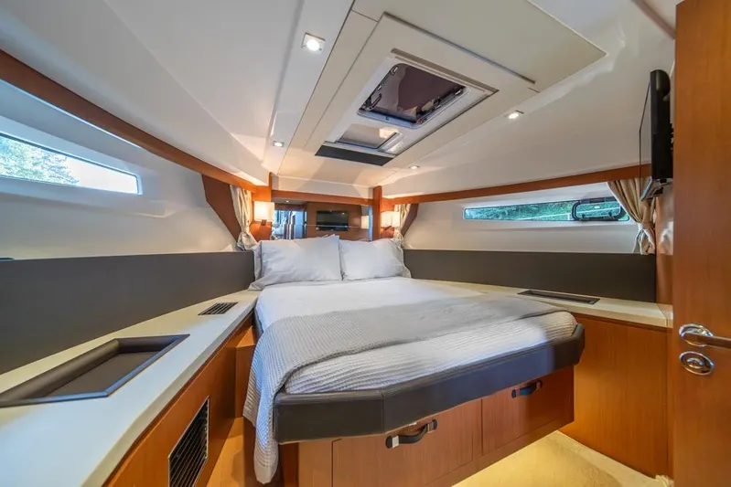  Yacht Photos Pics Luxurious cabin interior of 2016 Jeanneau Velasco 43F yacht with cozy bed and modern design.