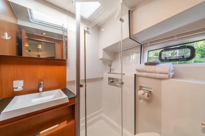  Yacht Photos Pics Luxurious bathroom in 2016 Jeanneau Velasco 43F yacht with modern fixtures and natural light.