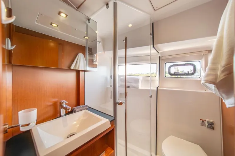  Yacht Photos Pics Luxurious bathroom interior of 2016 Jeanneau Velasco 43F yacht, featuring modern fixtures and wood accents.