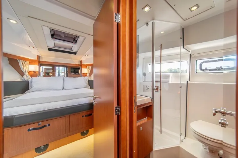  Yacht Photos Pics Luxurious interior of 2016 Jeanneau Velasco 43F yacht with bedroom and bathroom.