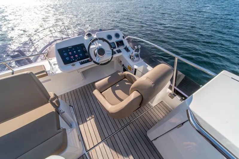  Yacht Photos Pics Flybridge helm of 2016 Jeanneau Velasco 43F yacht with modern controls and ocean view.