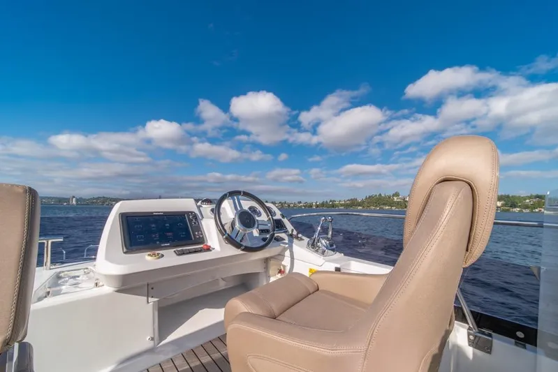  Yacht Photos Pics Flybridge helm of 2016 Jeanneau Velasco 43F yacht under clear blue sky.