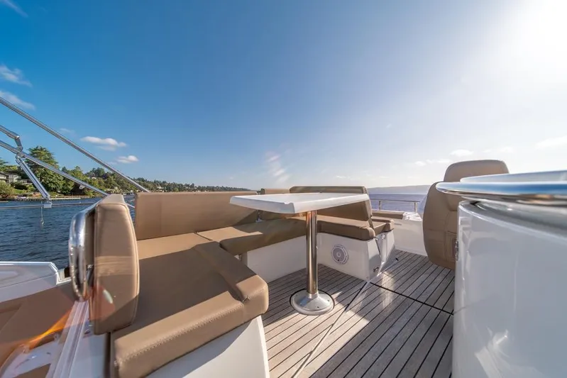  Yacht Photos Pics 2016 Jeanneau Velasco 43F yacht deck with seating and table, under clear blue sky.