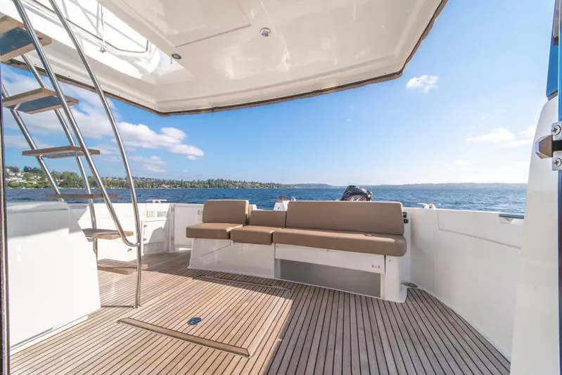  Yacht Photos Pics 2016 Jeanneau Velasco 43F yacht deck with seating, ocean view, and stairs.
