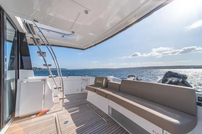  Yacht Photos Pics 2016 Jeanneau Velasco 43F yacht deck with seating, ladder, and ocean view.