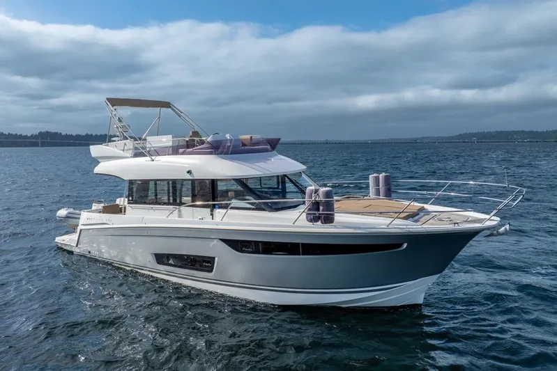  Yacht Photos Pics 2016 Jeanneau Velasco 43F yacht cruising on open water under cloudy skies.