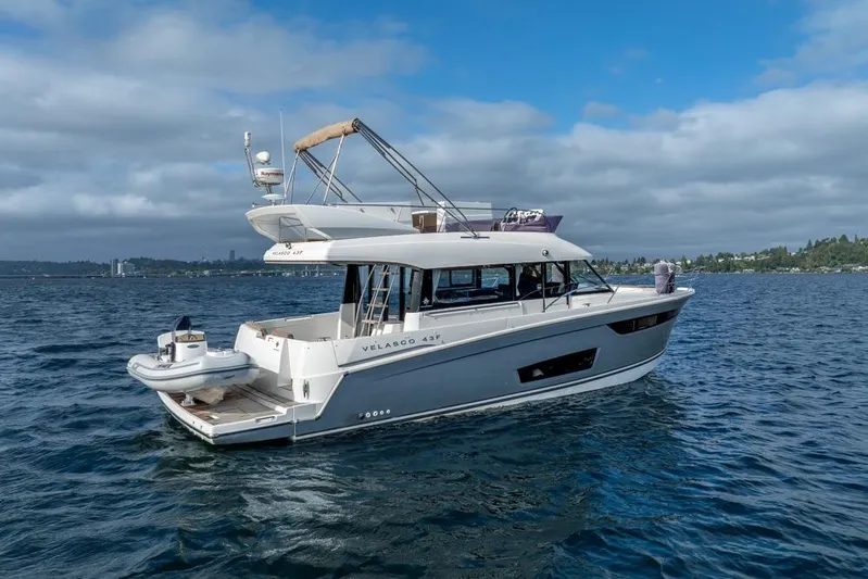  Yacht Photos Pics 2016 Jeanneau Velasco 43F yacht cruising on a calm, scenic lake.