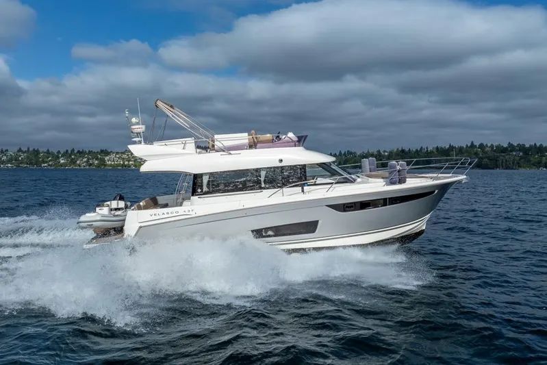  Yacht Photos Pics 2016 Jeanneau Velasco 43F yacht cruising on open water under cloudy skies.